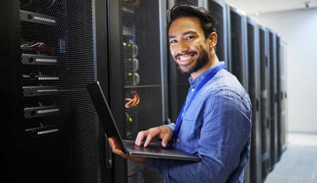 Man smiling while typing on computer